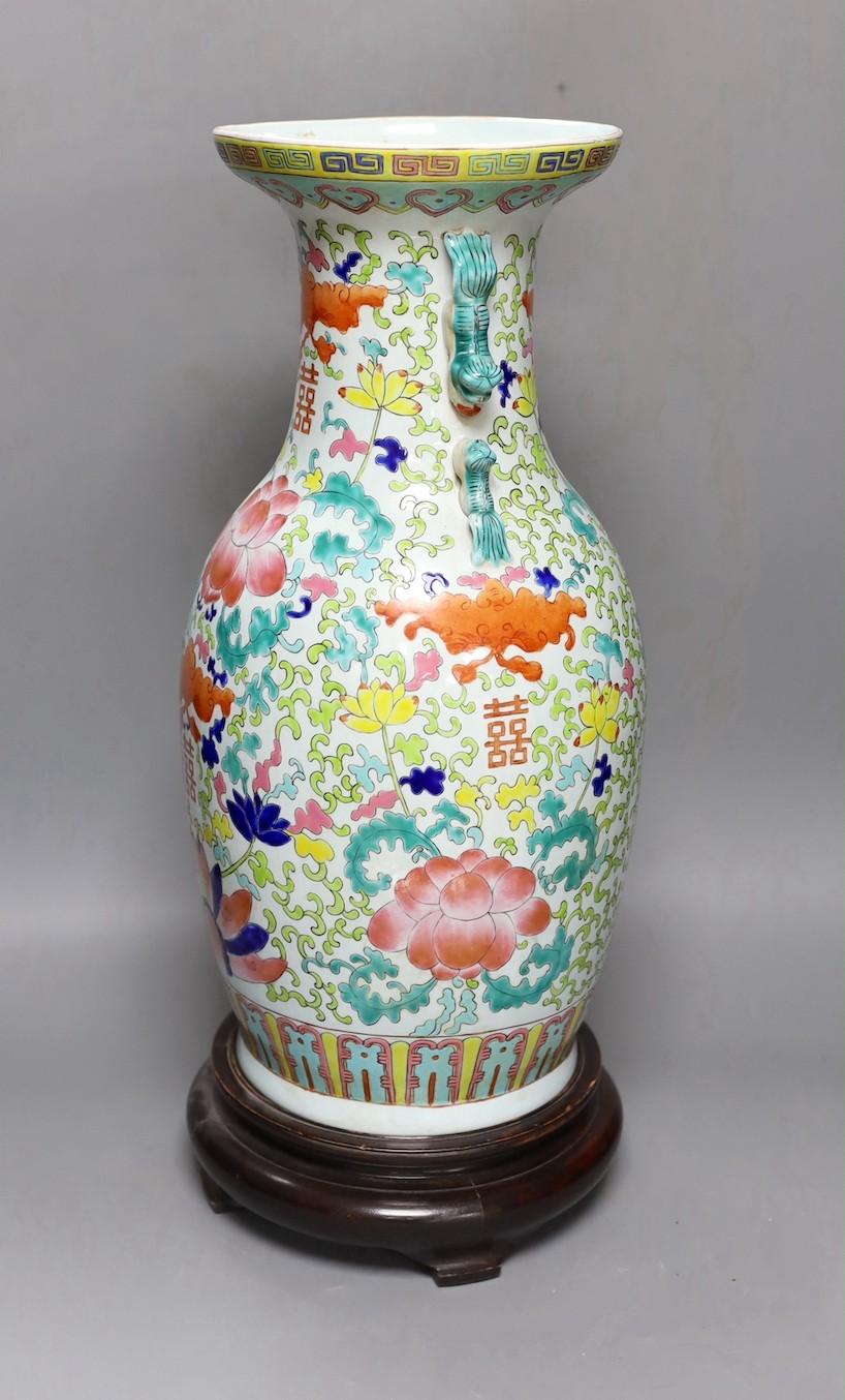 A large Chinese enamelled porcelain vase, on wood stand 53cm